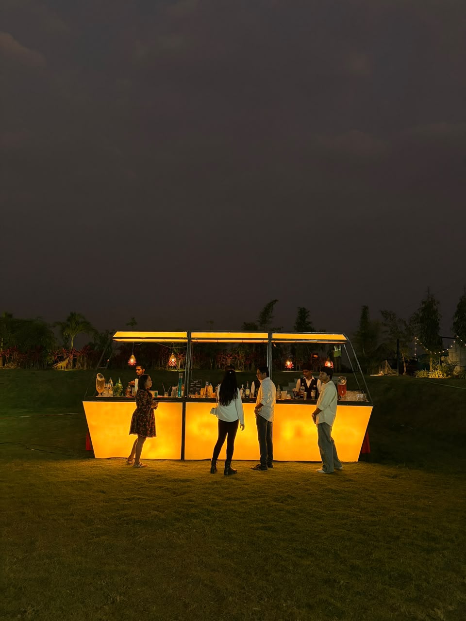 A warmly illuminated bar on the Garden Lawn